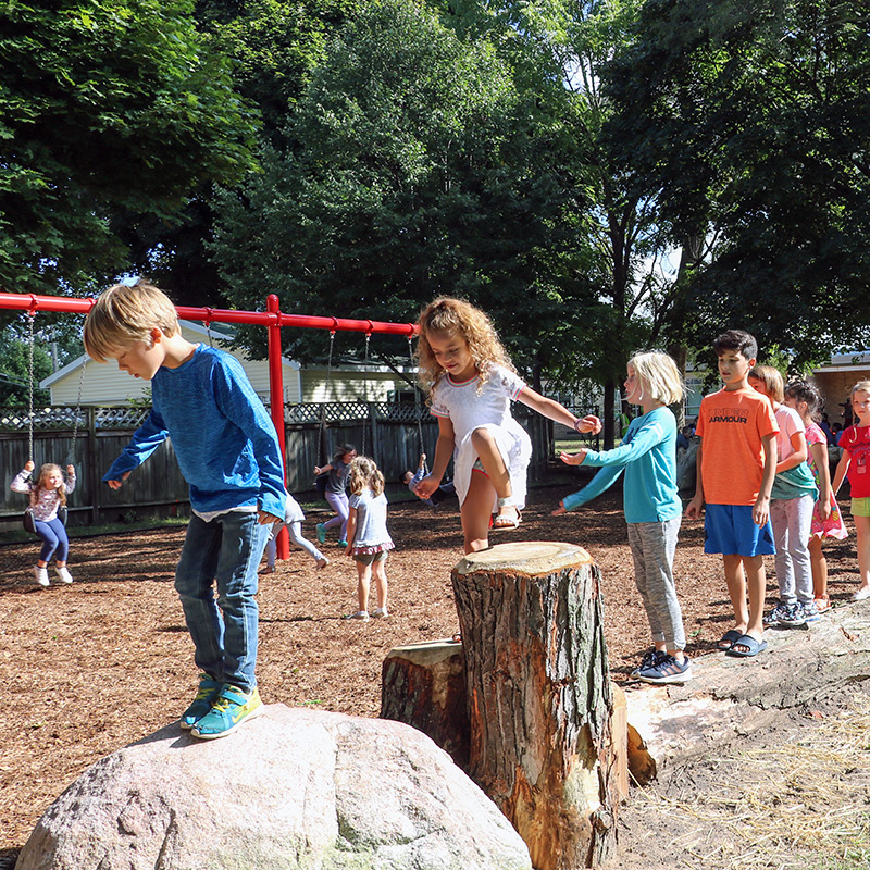 Children playing on natural features