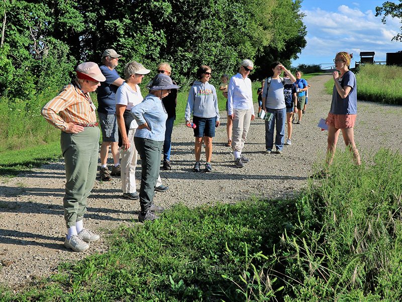 Naturalist leading a guided nature hike through along trail